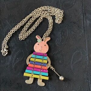 This Necklace Features an Enameled Rabbit Playing a Wooden Colorful Xylophone